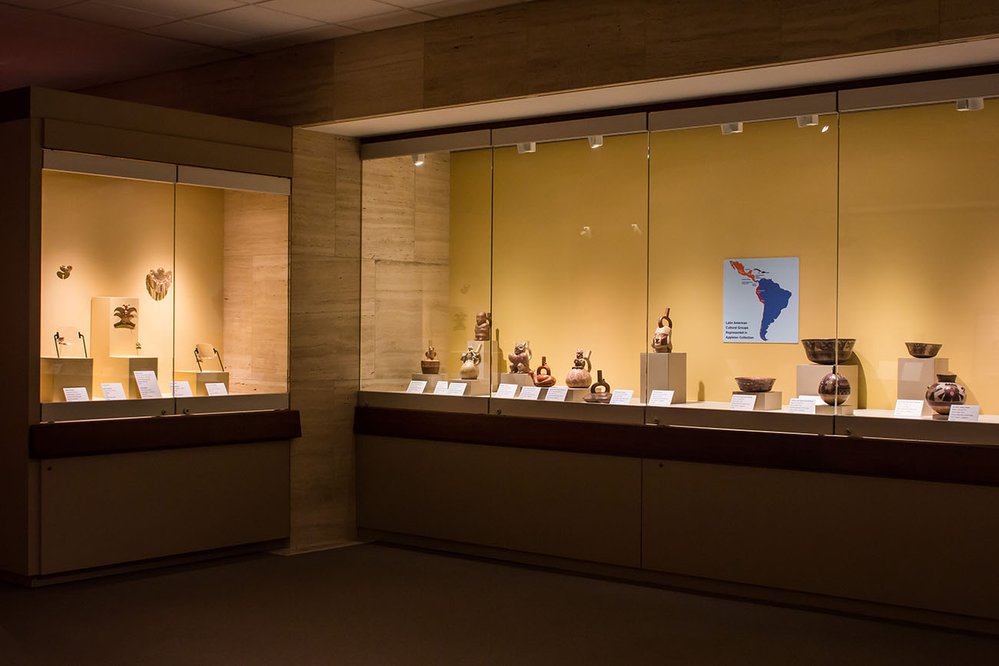 View of Pre-Columbian Gallery. There are various pre-columbian artifacts in glass cabinets.